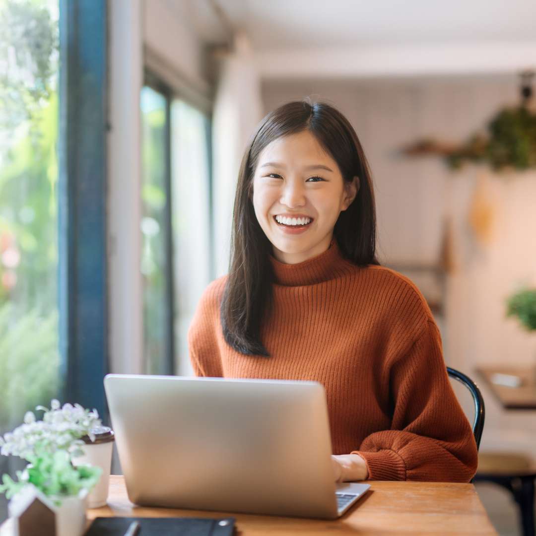 smiling woman using laptop